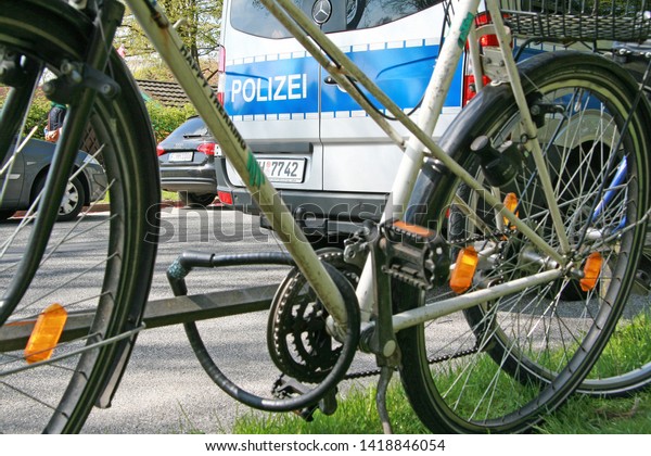 Hamburg, germany, 14.06.2017. A bike\
secured with a bicycle lock in front of a police car. The police\
advise to secure each bicycle with a good lock against\
theft.