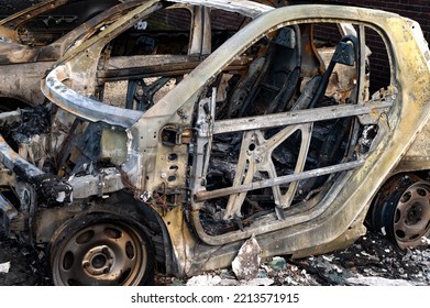 HAMBURG, GERMANY - Apr 24, 2022: A Closeup Of Burned-up Vehicles Surrounded By Burnt Rubble