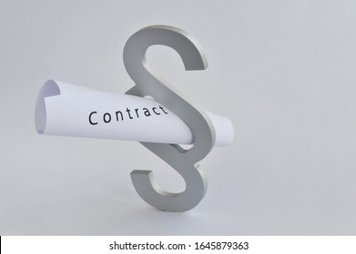 Hamburg /Germany - April 2, 2016: Close-up of a paragraph sign with a contract form - A symbol of contract law and legal aspects of contracts