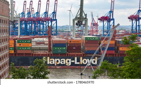 Hamburg, Germany - June 20, 2020: View on the middle part of a Hapag-Lloyd container ship on Elbe river. Harbour cranes in the background.