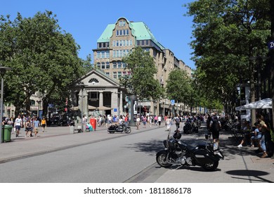 Hamburg, Germany - June 29, 2019: Heavy motorcycle and people walking in shopping street Monckebergstrasse in Hamburg, Germany on June 29, 2019