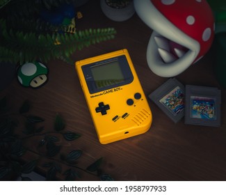 HAMBURG, GERMANY - Mar 16, 2021: The Original Gameboy DMG-01 In Yellow, Together With Super Mario Land 2