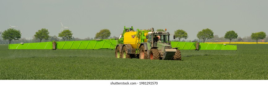 Hamburg, Germany - May 15, 2021: Tractor Fendt Favorit 824 With Dammann Profi Class Field Sprayer Applying Pesticides Against Pesticides