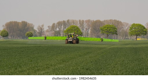 Hamburg, Germany - May 15, 2021: Tractor Fendt Favorit 824 With Dammann Profi Class Field Sprayer Applying Pesticides Against Pesticides