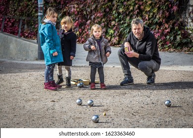 HAMBURG, GERMANY - OCTOBER 7, 2018: Father Plays Bocce Or Boules With His Three Daughters At Street
