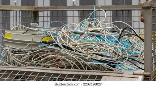 Hamburg, Germany - September 14, 2022: In The Data Center Are Old IT Network Cables And Power Cables Stored In A Lattice Box For Disposal