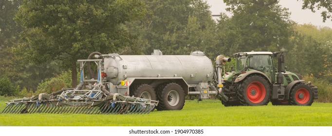 Hamburg, Germany - September 30, 2020: FENDT 930 Vario tractor with Bomech slurry spreader plus a drag shoe spreader