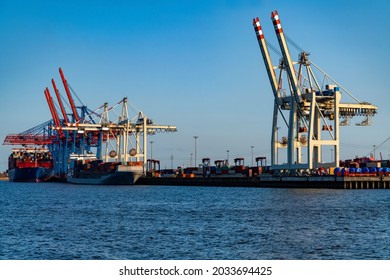 Hamburg Harbour panorama with tall cranes and colorful mixture of stacked oversea containers. High technology and automated transport and shipping. Symbol for globalization international exchange.