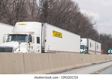 Hamburg, USA - April 6, 2018: Traffic With JB Hunt Trucks On Highway 78 In Pennsylvania With Cars Standing Waiting On Cloudy Day