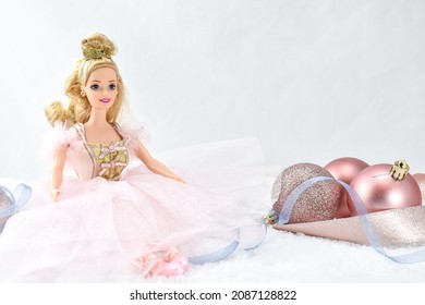 Hamburg, USA - December 7 2021: Mattel Barbie as Sugar Plum Fairy from The Nutcracker Christmas Ballet Posing with Ribbon and Pink Ornaments