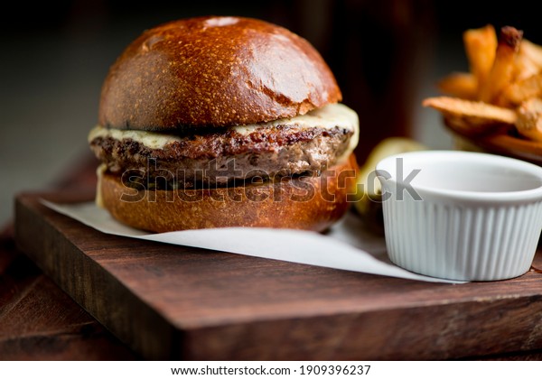 Hamburger. Bacon Cheeseburger. Classic traditional\
American bar, restaurant entree. Beef hamburger with Swiss and\
cheddar cheeses served with lettuce, tomato, onion and hand cut\
french fries. 