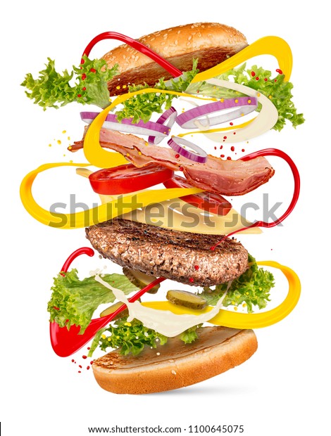 hamburger cheeseburger\
explosion creative cooking concept flying ingredients isolated on\
white background