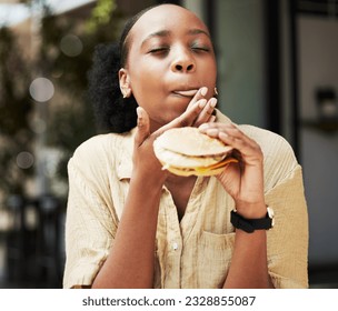 Hamburger, fast food and black woman eating a brunch in an outdoor restaurant as a lunch meal craving deal. Breakfast, sandwich and young female person or customer enjoying a tasty unhealthy snack - Shutterstock ID 2328855087