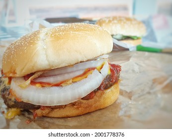 Hamburger is a fast food make from bun, meat, cheese and vegetable  in fastfood restaurant, unhealthy food or fat concept