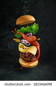 Hamburger with floating ingredients on dark background. Creative still life concept and advertisement - Shutterstock ID 1823466098