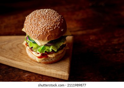 Hamburger With Sesame Seeds Bun. Wooden Background. Food Concept. Hamburger Day.