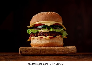 Hamburger With Sesame Seeds Bun. Wooden Background. Food Concept. Hamburger Day.