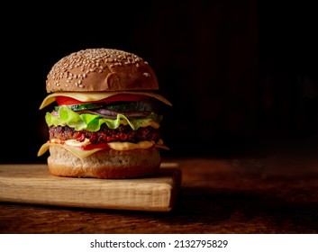 Hamburger With Sesame Seeds Bun. Wooden Background. Food Concept. Hamburger Day.