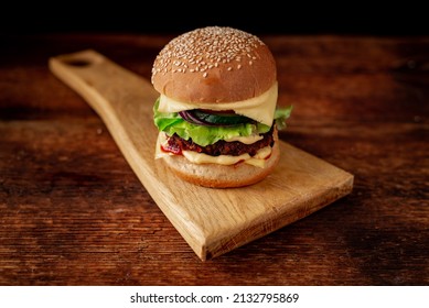 Hamburger With Sesame Seeds Bun. Wooden Background. Food Concept. Hamburger Day.