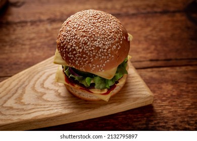 Hamburger With Sesame Seeds Bun. Wooden Background. Food Concept. Hamburger Day.