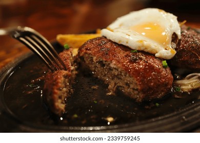 Hamburger steak with egg on top, commonly served in Japanese family restaurants. - Powered by Shutterstock