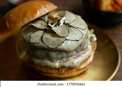 Hamburger Topped With Slice Black Truffles. Truffle Is A Very Expensive, Aromatic And Rare Garnish.