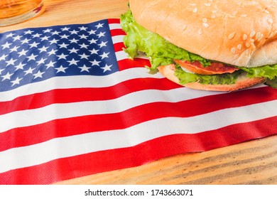 Hamburger With U.s. Flag On Wooden Bottom. Independence Day Concept 4th Of July.