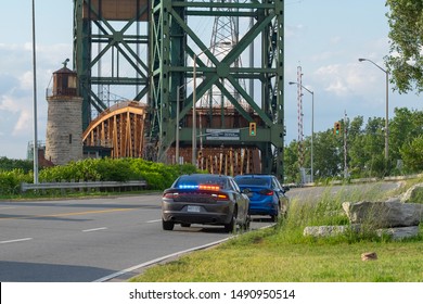 Hamilton, Canada - Aug 28, 2019: Undercover Unmarked Police OPP Vehicle With Flashing Red And Blue Lights Has Pulled Over A Car On The Side Of The  Road. Dangerous, Careless Driving, Speeding, DUI.