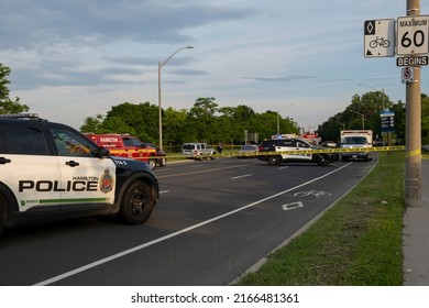 Hamilton Ontario Canada Jun 11 2022: Police SUV Trucks, Paramedics, Ambulances, Fire Trucks Present At Accident Scene At Area Closed Off With Yellow Tape. Multi Vehicle Fatal Crash At York Boulevard.