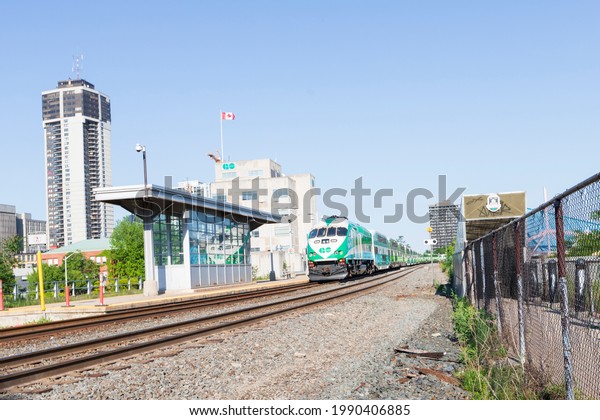 HAMILTON, Ontario, Canada - June 2021: Go\
Transit train is parked on the railway at the Go Transit train\
station in downtown\
Hamilton.