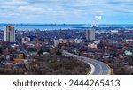 Hamilton Ontario city skyline, downtown buildings, horizon, and the Lake Ontario in the distance in Canada, view from the Niagara Escarpment in Sam Lawrence Park