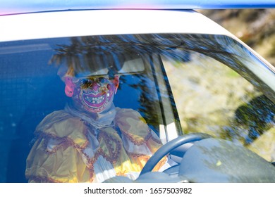 HAMMARKULLEN, SWEDEN - MAY 25, 2019: Man With Face Mask Driving A Car During The Yearly Carnival In Hammarkullen, Sweden