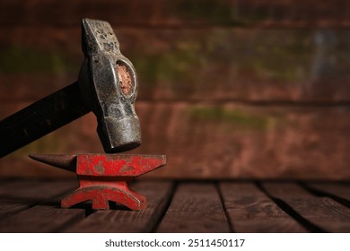 Hammer and anvil on the wooden workbench background front view. - Powered by Shutterstock