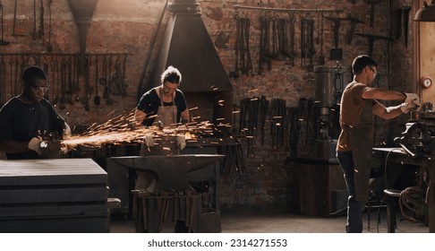 Hammer, anvil and sparks with a men working in a foundry for metal work manufacturing or production. Industry, welding and trade with a blacksmith people in a workshop, plant or industrial forge - Powered by Shutterstock