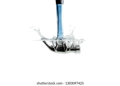 A Hammer Falling Into The Water. Hammering The Water With A Hammer And A Great Splash Of Water. The Concept Of Failure, The Impossibility Of Reaching An Agreement. Construction Renovation.