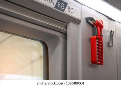 Hammer glass breaker on the train, tram, bus and car. Red safety glass hammer mounting or hanging  near the windows glass for using to break the glass in case accident.