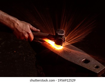 Hammer In Hand Hits The Anvil And Sparks Fly