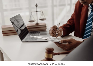 hammer judge law book and the scales of justice on the table in the lawyer's office. legal justice concept Businessman in a suit or lawyer working on documents Law, advice and justice concept - Powered by Shutterstock