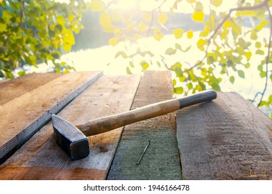 Hammer And Nail On Boards. Sun Flare. Building A Treehouse. High Quality Photo