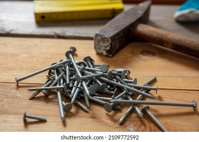 Hammer And Nail Stack On Wood. Carpenter Work Bench Table, Closeup View, Joinery Workshop