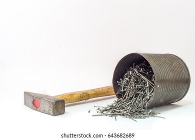 hammer and a lot of nails pour down from container on white background.
