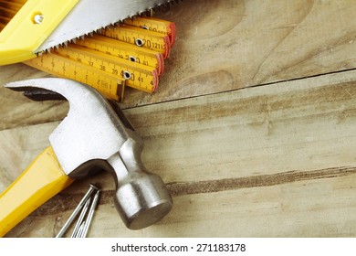 Hammer, Nails, Ruler And Saw On Wood