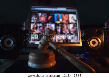 Hammer on the background of the computer screen, illegal site with adult content,