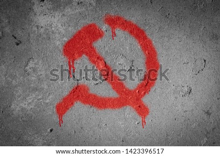 Hammer and sickle,Communism symbol spray painted on the wall 