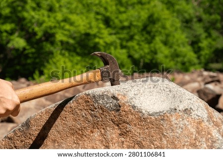 Hammer striking the ringing rocks in Upper Black Eddy, Pennsylvania, USA.