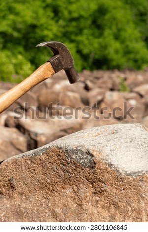 Hammer striking the ringing rocks in Upper Black Eddy, Pennsylvania, USA.