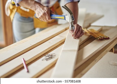 Hammering Nails Into Wooden Planks