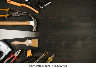 Hammers, Saw, Pliers Top View With Place For Text. Tool In Workshop On Wooden Table 