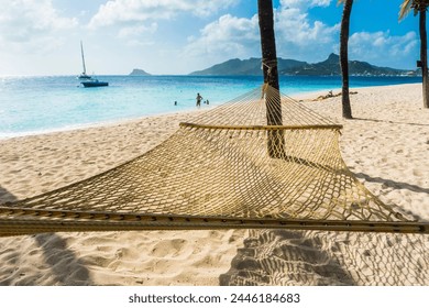 Hammock between two palms on a sandy beach, Palm Island, The Grenadines, St. Vincent and the Grenadines, Windward Islands, West Indies, Caribbean, Central America