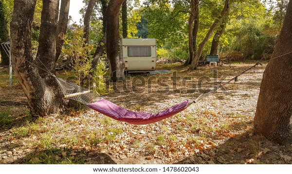 hammock caravan in a camping among trees holidays \
by the nature